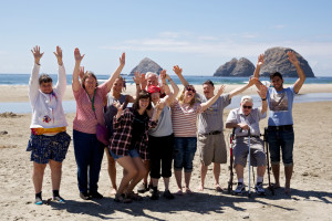 Hands in the air for the ocean! Enjoying the breeze and sunshine during L'Arche Seattle's community vacation.