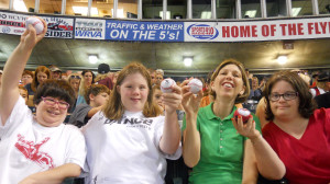 LArche Metro Richmond founders Virginia, Kel, Hannah, and Anne build community by cheering on their hometown baseball team.