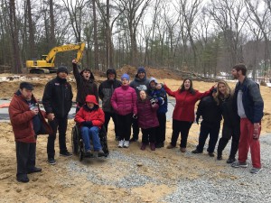 L'Arche Boston North core members and assistants celebrate at the site of their new home.